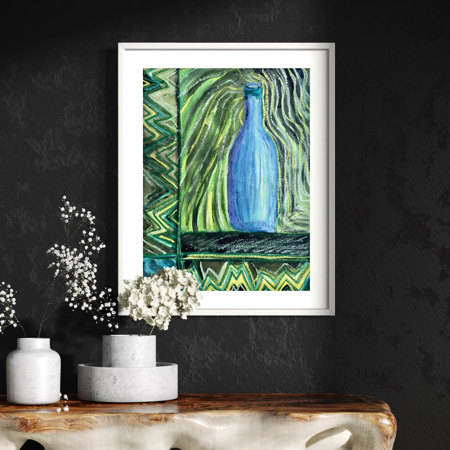 Framed artwork of a blue bottle against a green abstract background on a dark wall.