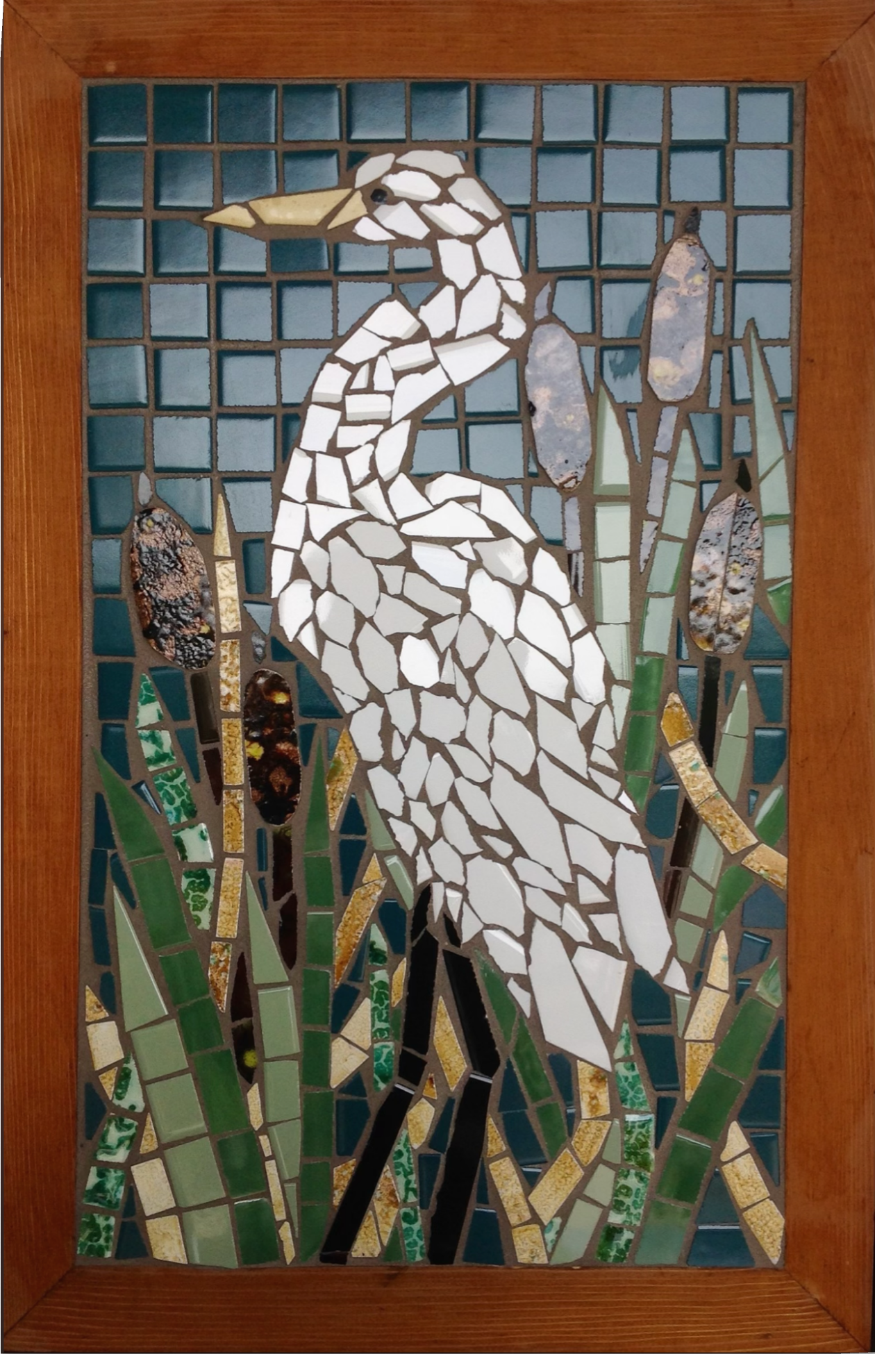Mosaic artwork of a heron in a natural setting with a wooden frame.