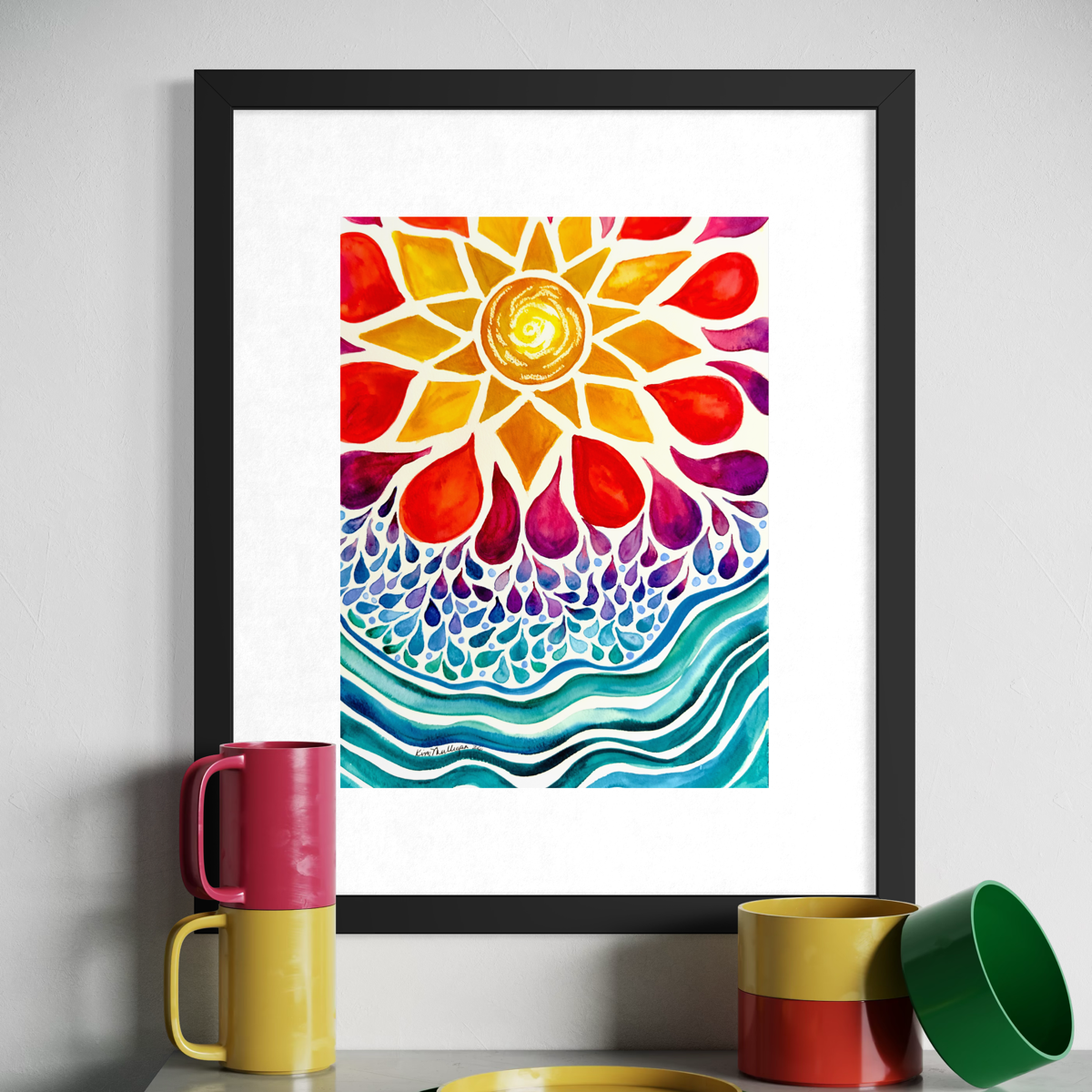 A framed art print featuring a vibrant, colorful watercolor sunflower design with teal and purple wavy patterns below, displayed on a shelf next to stacked and stacked mugs.