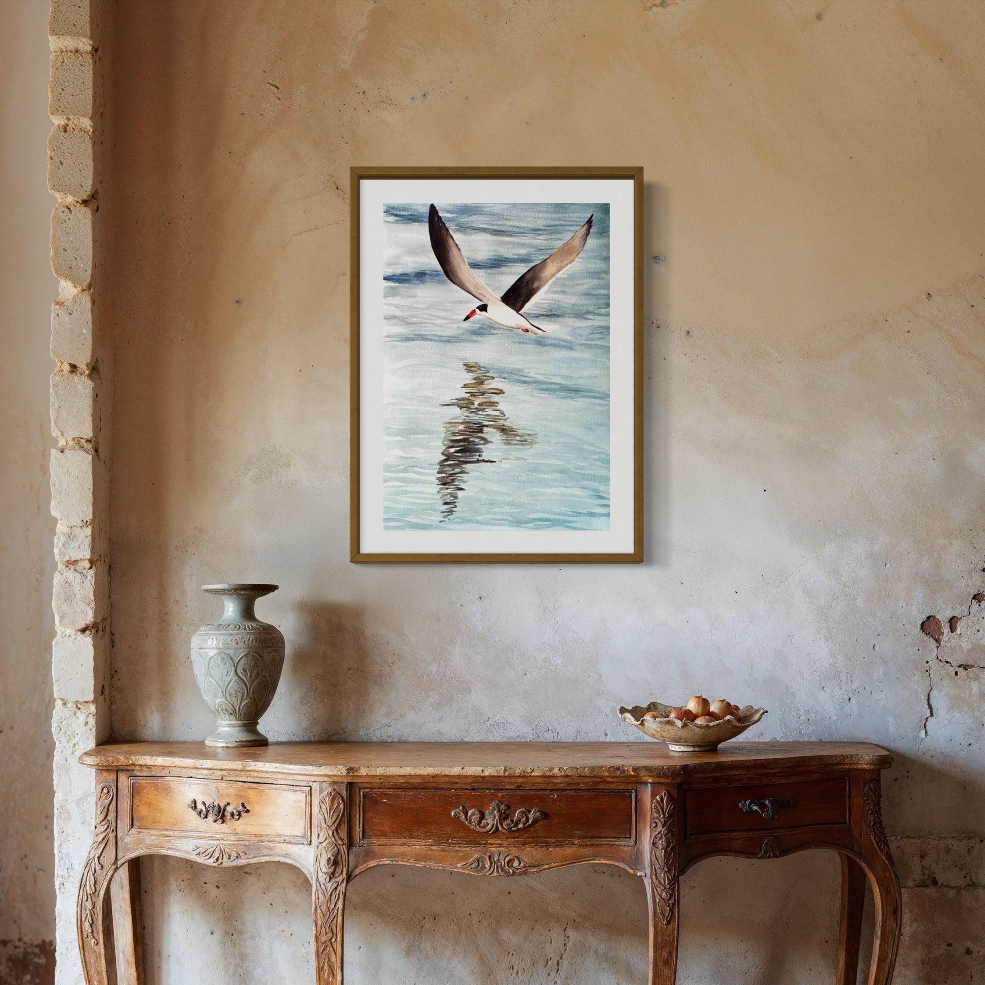 Framed watercolor artwork of a black skimmer bird flying over water.