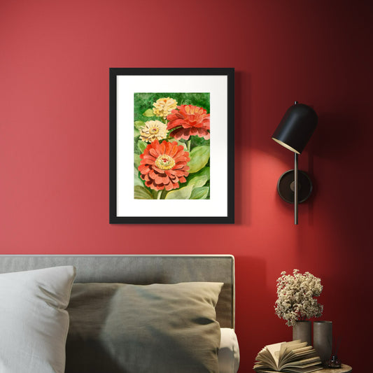 Framed watercolor painting of yellow and red zinnia flowers with green leaves.