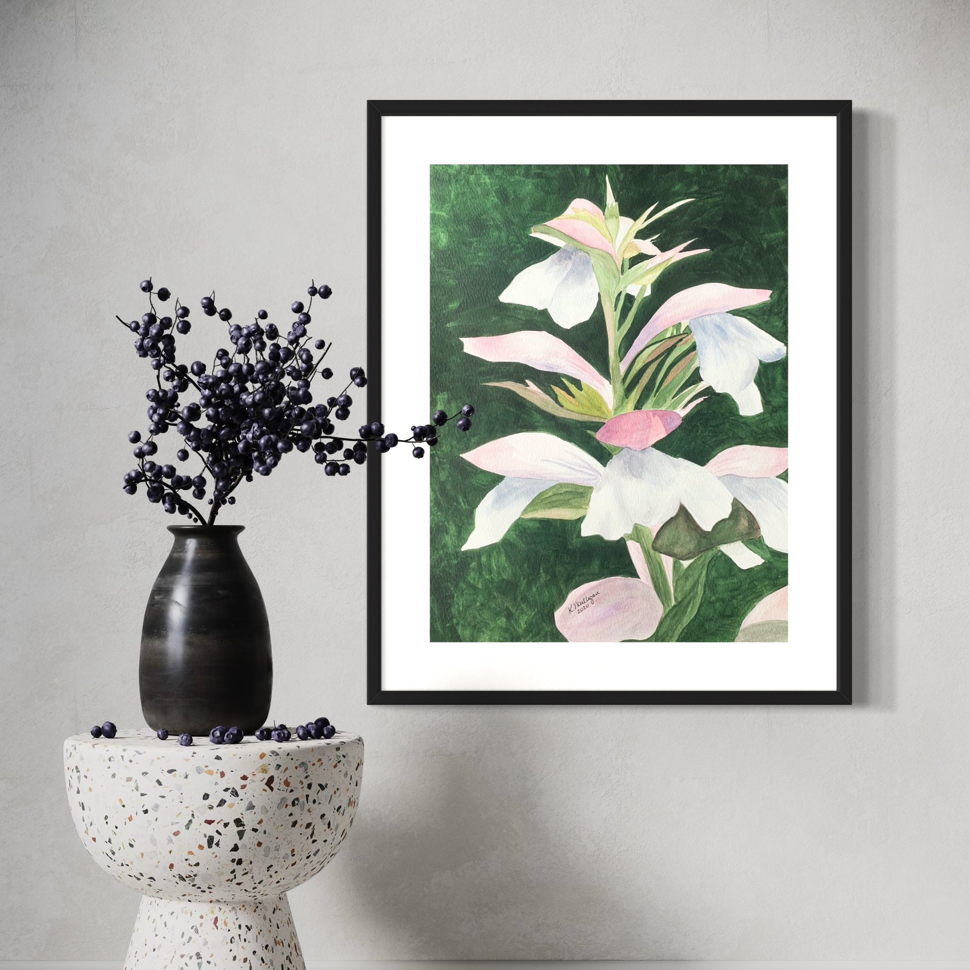 Framed watercolor floral artwork on a wall.