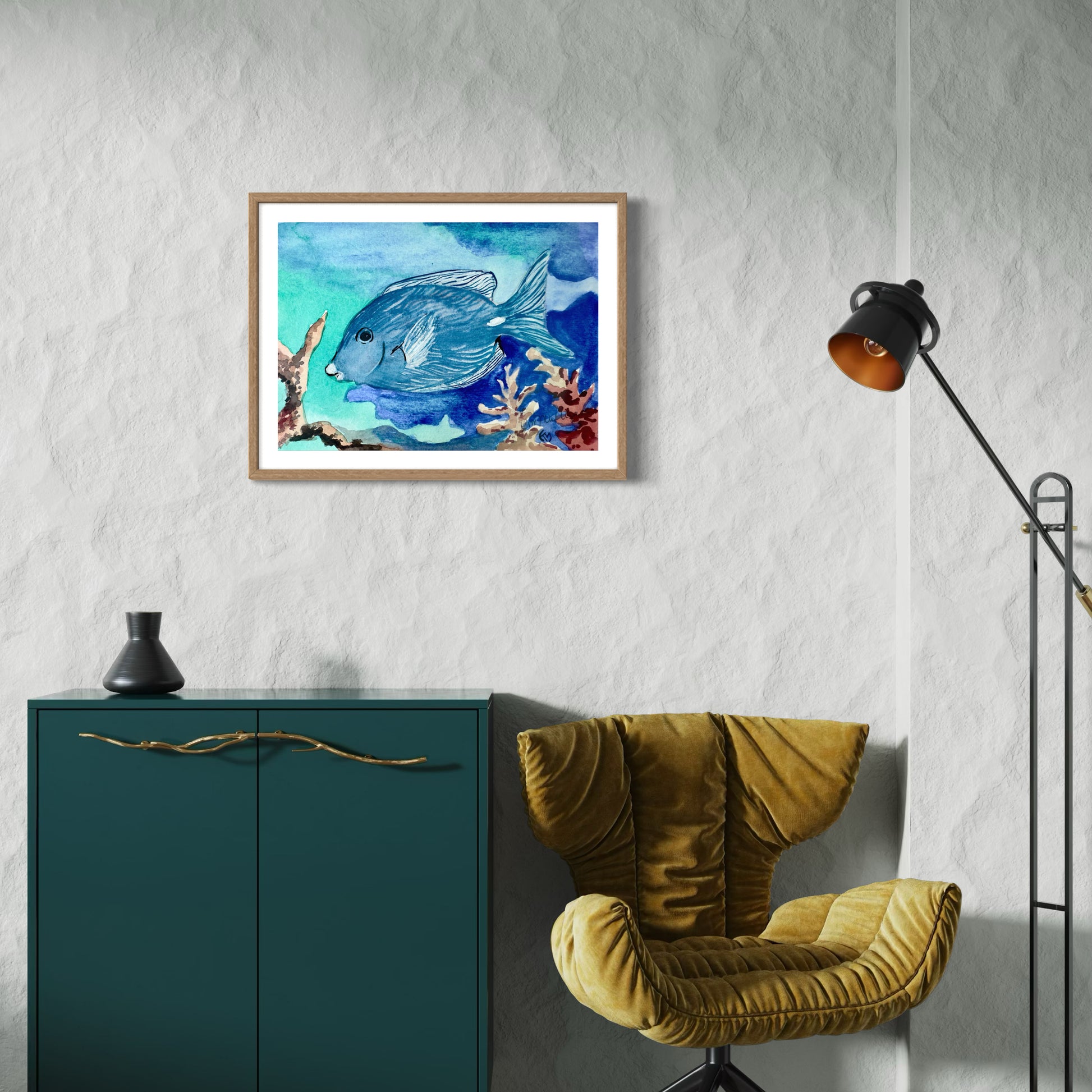 Framed watercolor painting of a blue tropical fish and coral.