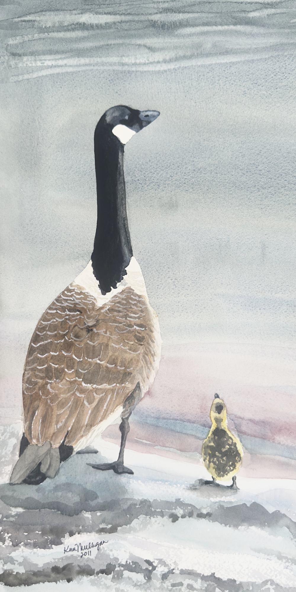 Watercolor painting of a Canada goose and gosling looking out over the water from a beach