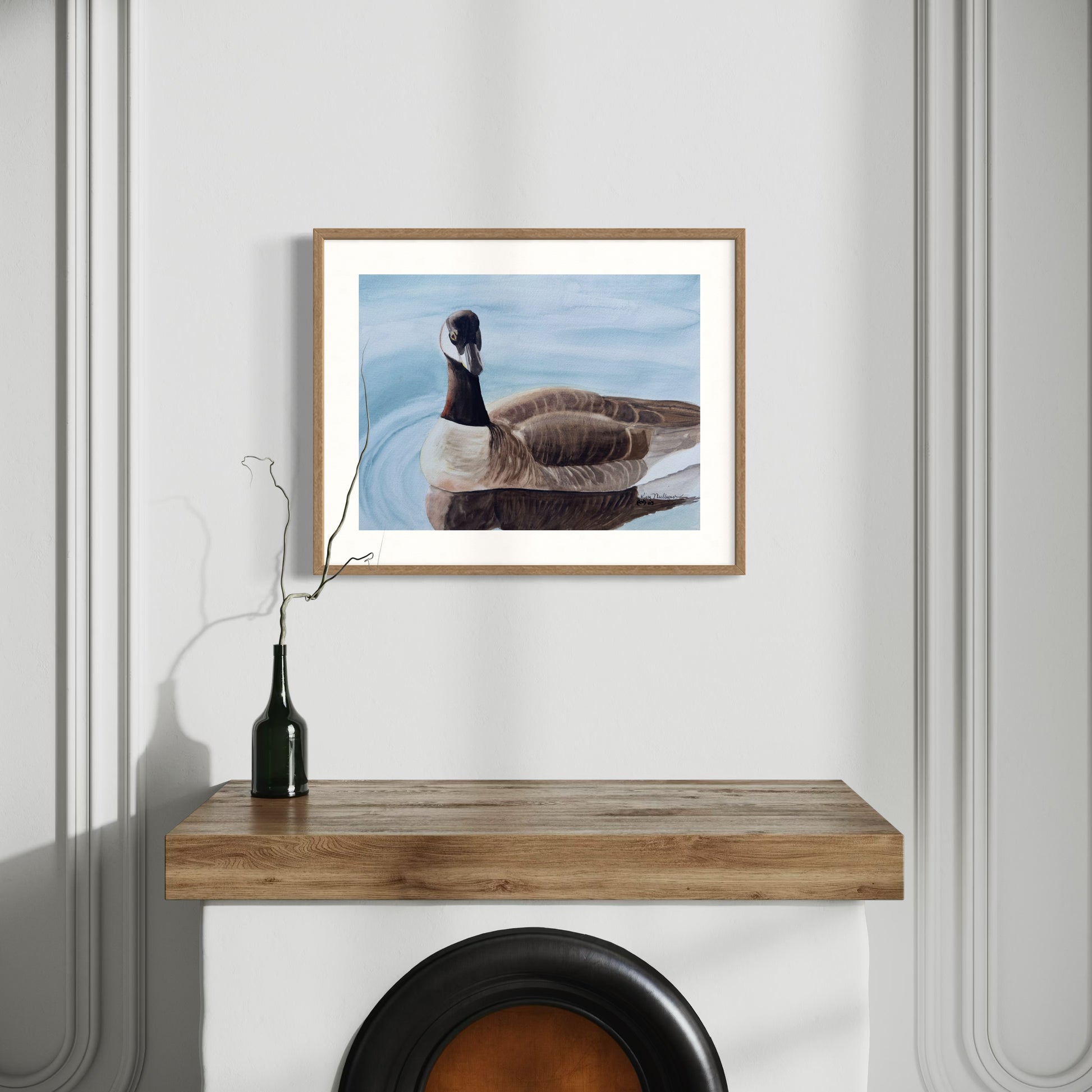 Framed watercolor painting of a solitary Canada goose bird on calm water.