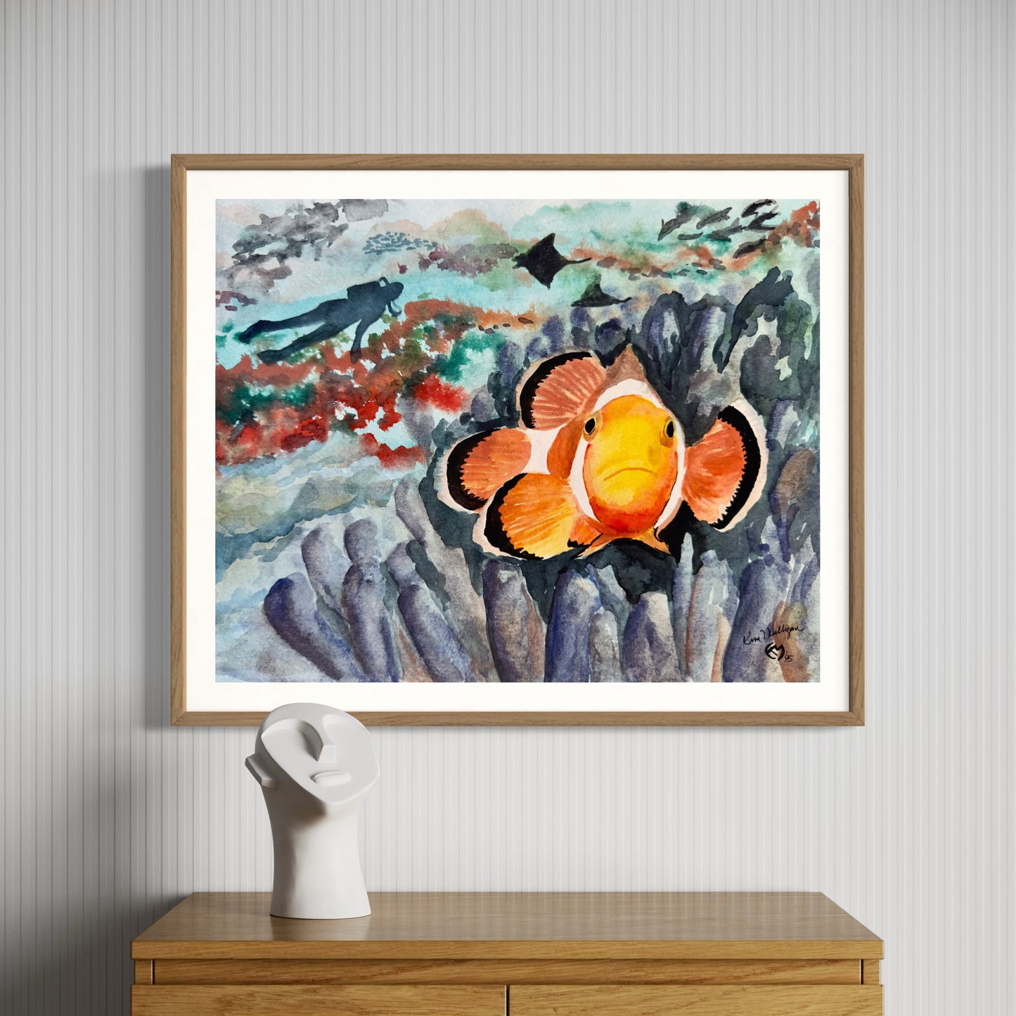 Framed artwork of a clownfish  underwater scene with sting ray,scuba diver and anemone.