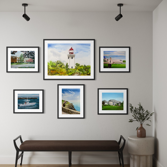 Wall with framed pictures of landscapes and a bench below.