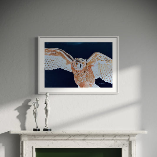 Framed artwork of an owl on a wall above a fireplace with two small sculptures.