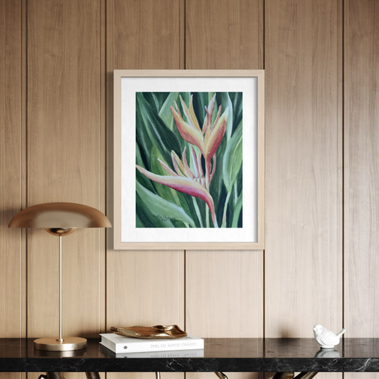 Framed watercolor painting of a yellow orange and red heliconia flower with green leaves in the background.