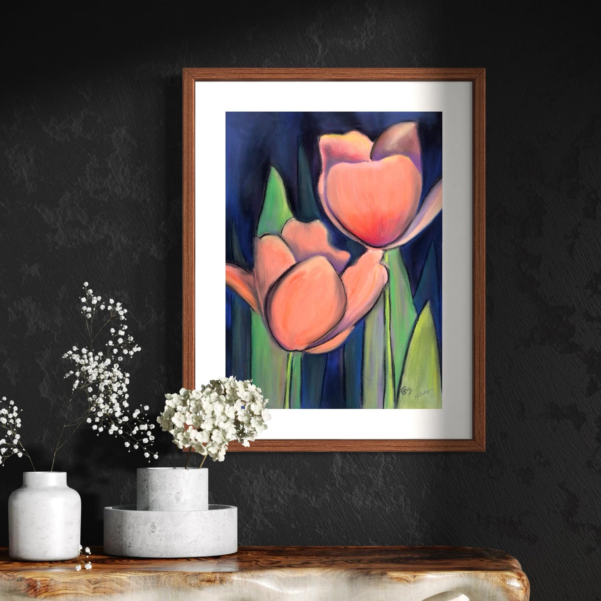 Framed watercolor and pastel artwork of a tulip on a dark wall with decorative vases and flowers.