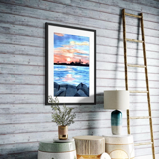 Framed watercolor painting of inlet scene with sunset and light house silhouette. 