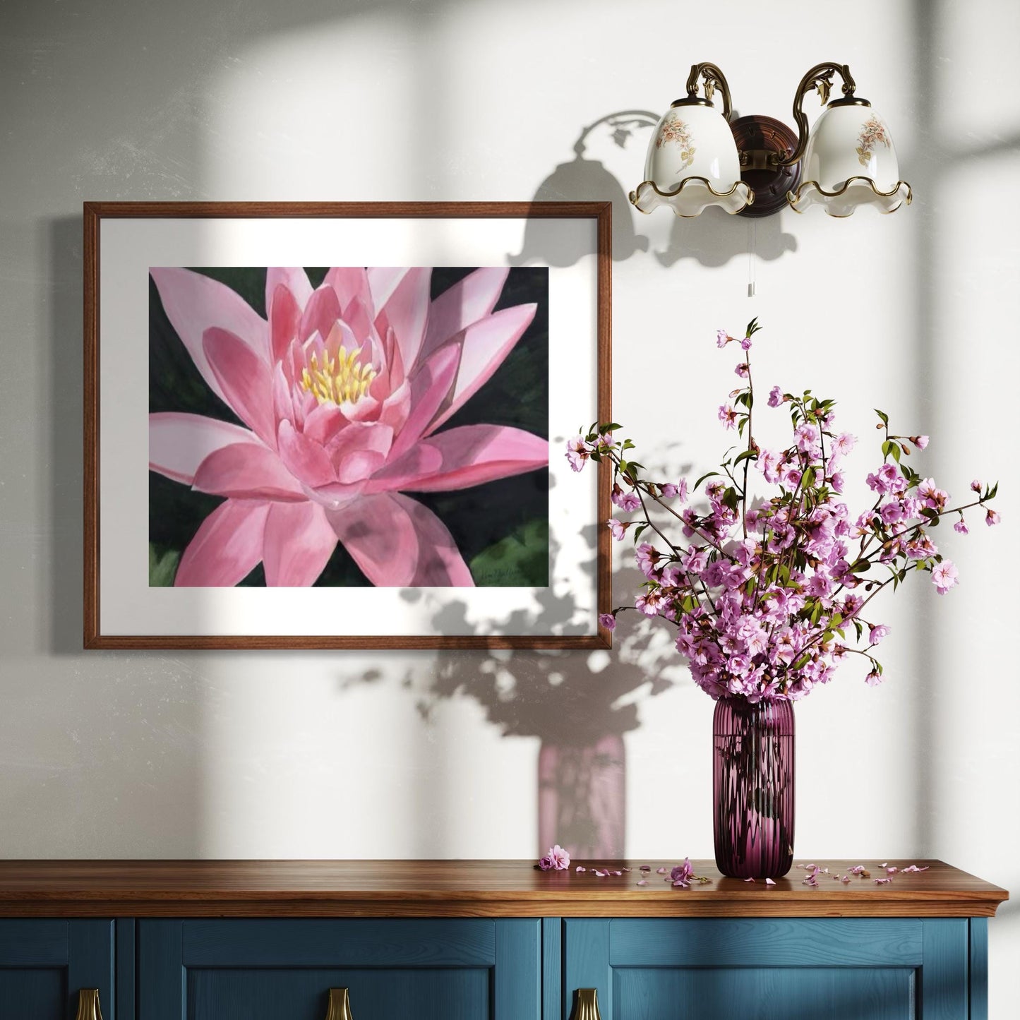 Framed watercolor painting of a pink waterlily ith dark green background.