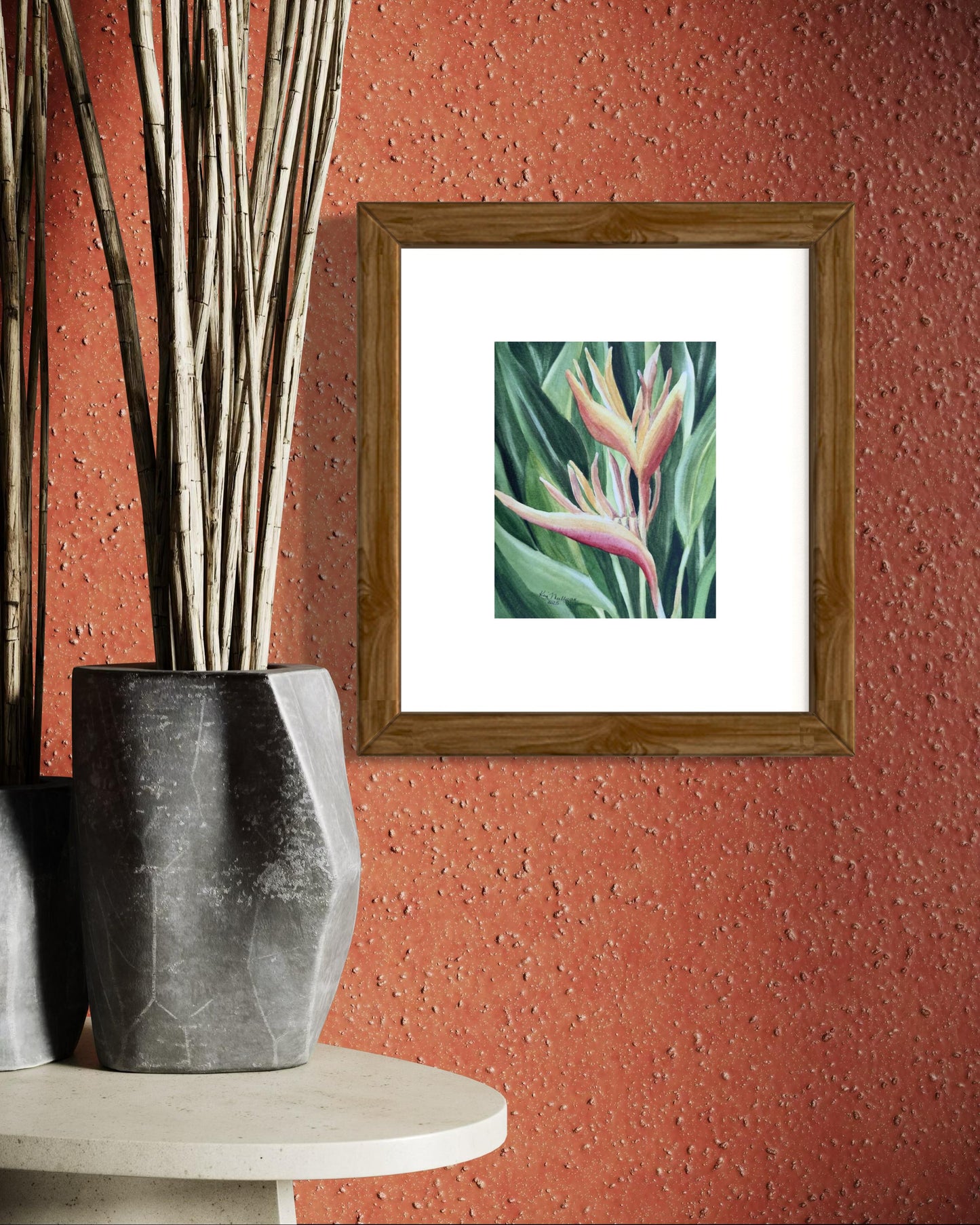 Framed Watercolor painting of yellow and orange heliconia flower with green leaves.