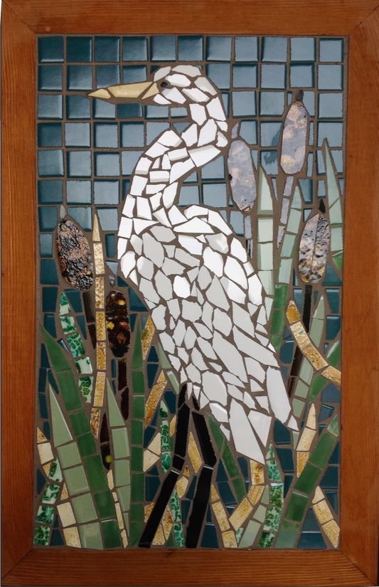 Mosaic artwork of a heron in a natural setting with a wooden frame.
