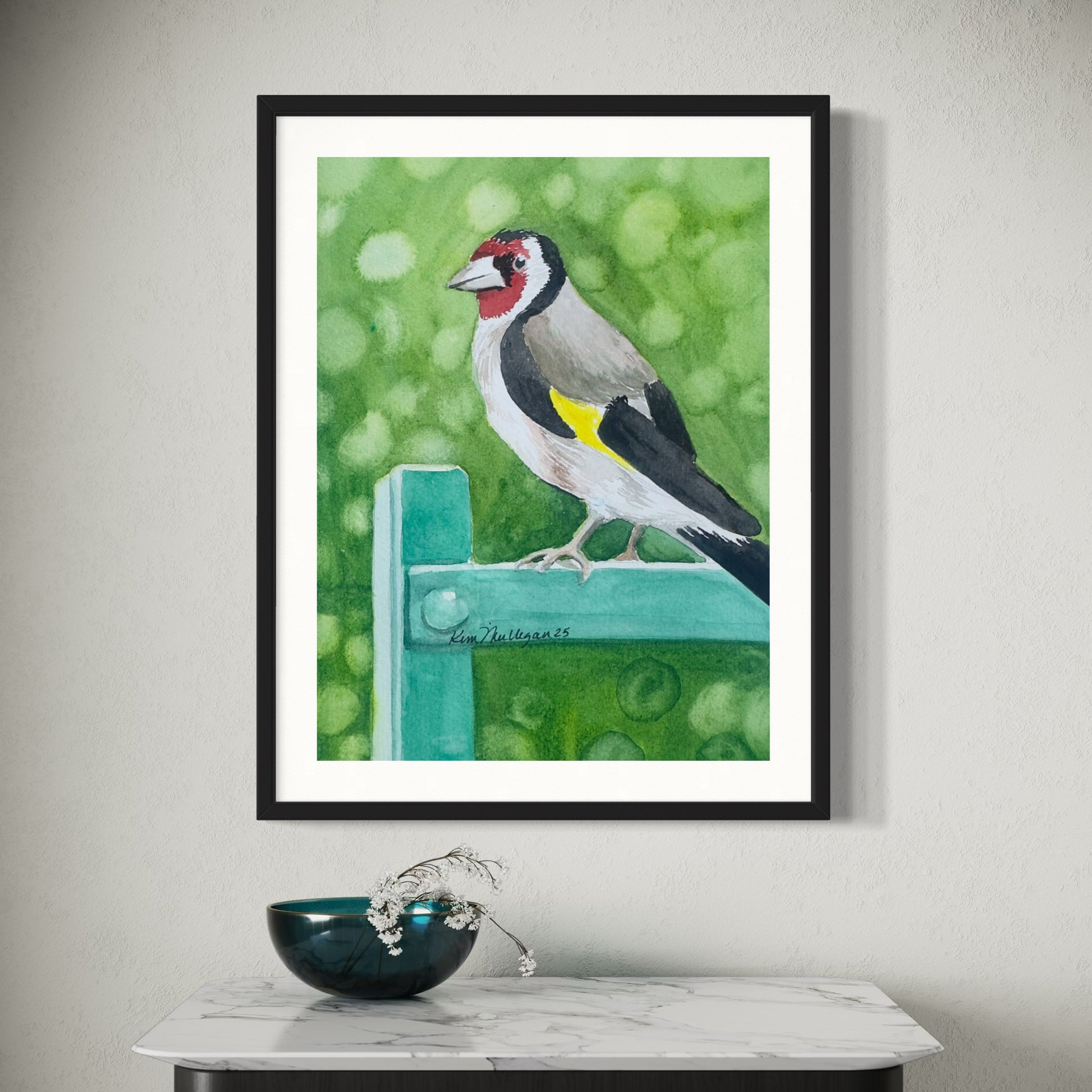 Framed watercolor painting of a eurasian gold finch bird.