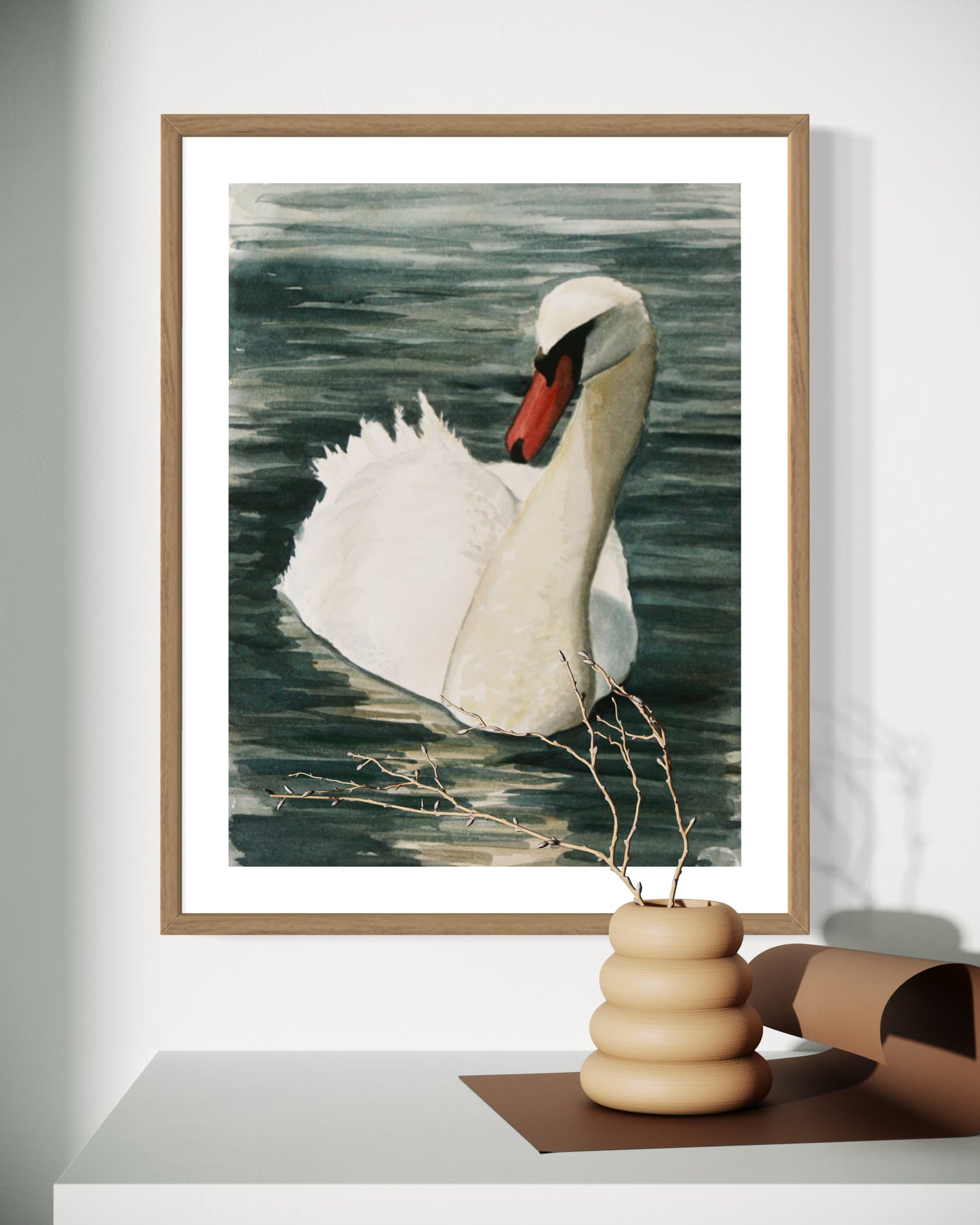 Framed watercolor painting of a mute swan on dark green water.