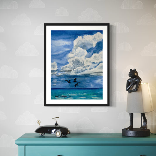 Framed watercolor artwork of a blue sky with clouds over the ocean with sea gulls in flight.
