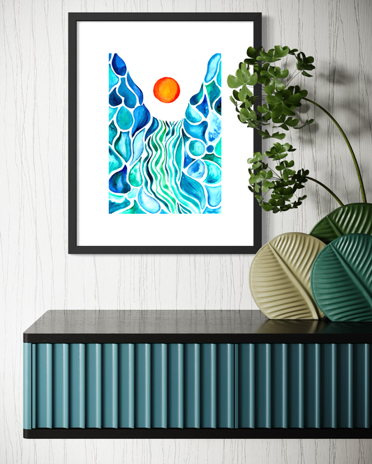 Framed abstract colorful wall art hanging above a black shelf, featuring blue and teal wavy forms with an orange sun on a white background. A green trailing plant and decorative leaf-shaped vases sit on the shelf against a white wood wall.