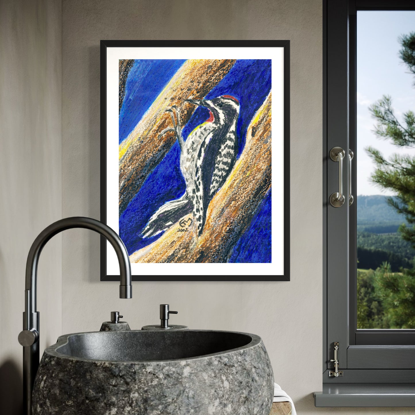 Framed artwork of a woodpecker on a branch above a modern bathroom sink.