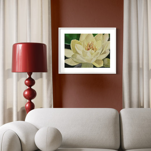 Framed watercolor artwork of a yellow waterlily flower on a wall above a sofa with a red lamp.
